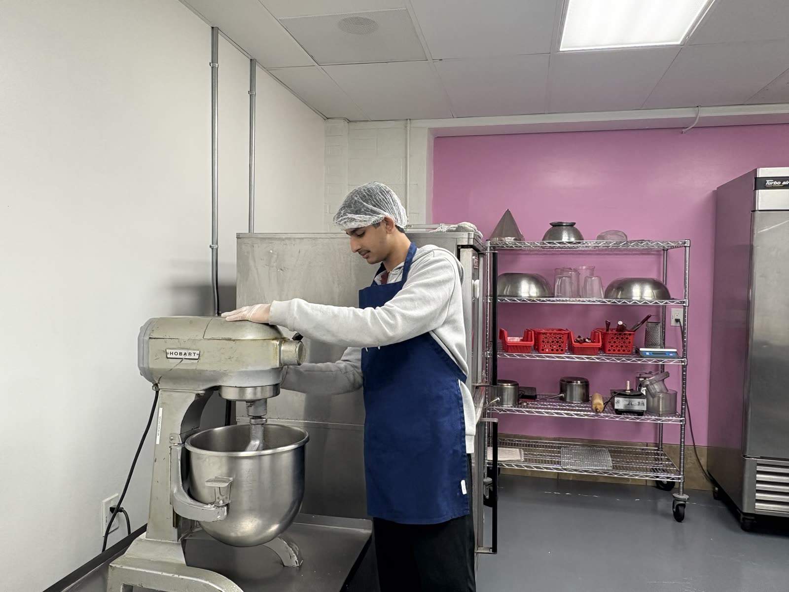 Ayaan mixing dough at the commercial kitchen